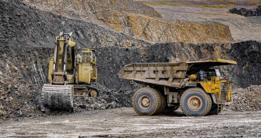 Digger and mine truck showing what is haulage in mining
