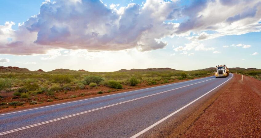 Truck on rural Pilbara road demonstrating weather related logistics challenges in Australia